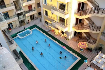 a group of people in a swimming pool in a building at Swemeh hills resort in Sowayma
