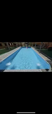 a large swimming pool with blue water at شاليهات تلال اشتفينا in Ajloun