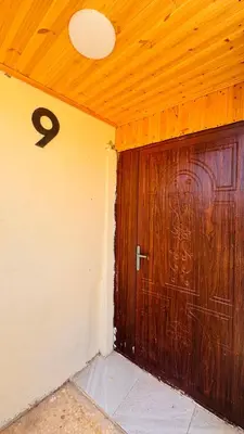 a room with a large wooden door with the number at عجلون - ajloun اشتفينا -9 in Ajloun