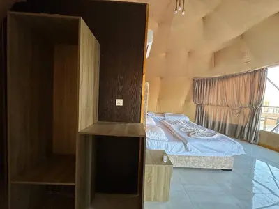 a small bedroom with a bed and a window at Camp Imran Khan Wadi Rum in Aqaba