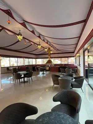a restaurant with chairs and tables and a ceiling at Terra Nova Camp in Wadi Rum