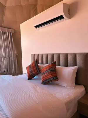 a bed with two pillows sitting on top of it at Terra Nova Camp in Wadi Rum