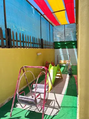 a room with a playground with a swing at شاليه بانا جرش in Jerash