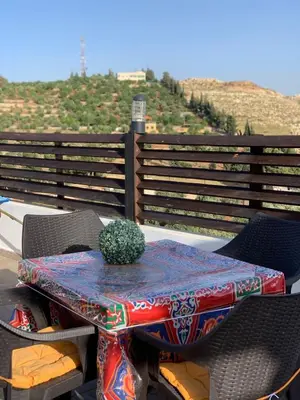a table with a cactus on top of a balcony at شاليه بانا جرش jerash