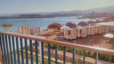 a view of a body of water from a balcony at Cozy Apartment with Private Beach, couples and families only in Aqaba