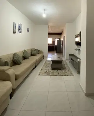 a living room with a couch and a table at Murjan in Amman