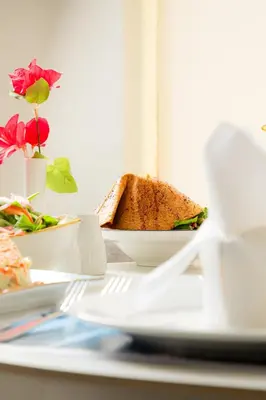 a plate of food with a sandwich on a table at Armada Avenue Hotel Amman in Amman