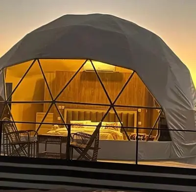 a tent with chairs and a table on a boat at Desert rose in Al Jafr