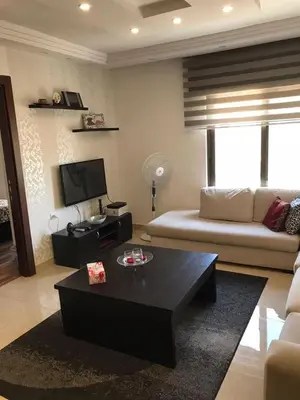 a living room with a couch and a coffee table at Peaceful apartment in Amman 7th Circle near Cozmo in Amman