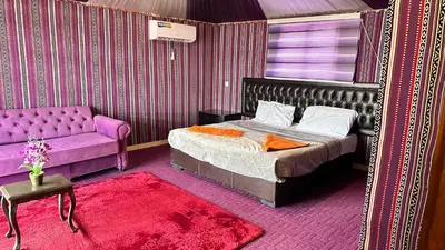 a bedroom with a bed and a couch at Sultan rum magic camp in Aqaba