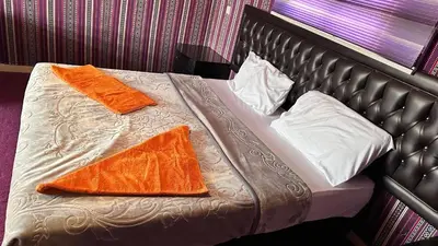 a bed with two orange towels on it at Sultan rum magic camp in Aqaba
