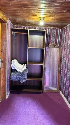 an empty closet in a room with purple carpet at Sultan rum magic camp in Aqaba