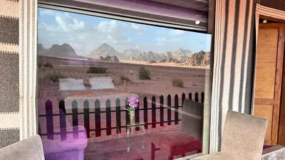 a room with a view of the desert from a window at Sultan rum magic camp in Aqaba