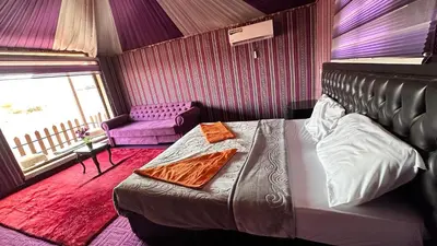 a bedroom with a bed and a chair and a window at Sultan rum magic camp in Aqaba