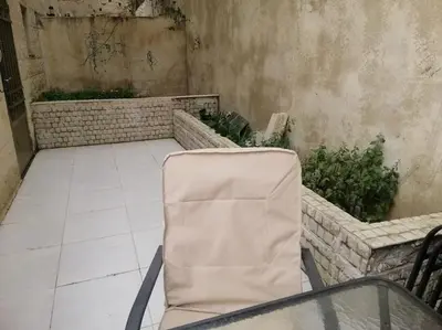 a chair sitting on a table in a patio at Humble house in Amman