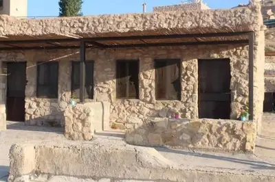 a stone building with a bunch of windows at Tafila-Mataan in Al Jafr