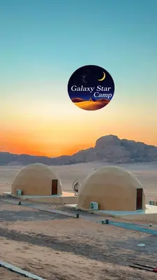 a frisbee flying over two domes in the desert at RUM GALAXY lUXURY CAMP in Disah