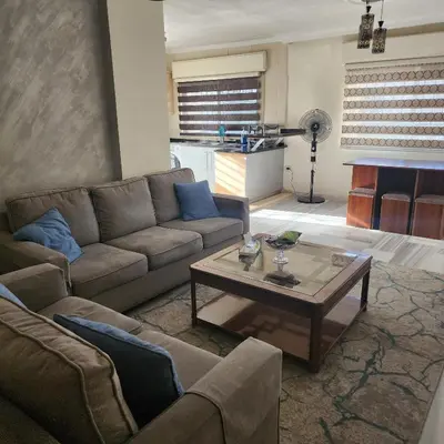 a living room with a couch and a coffee table at Eyad's Apartment in Amman