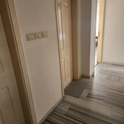 an empty room with a door and a hallway with a floor at Eyad's Apartment in Amman