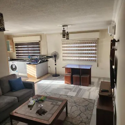 a living room with a couch and a table at Eyad's Apartment in Amman