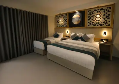 a hotel room with two beds and a window at Aroma Hotel in Aqaba