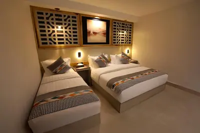 two beds in a hotel room with two beds sidx sidx sidx at Aroma Hotel in Aqaba