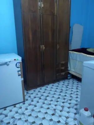 a bathroom with a shower and a tiled floor at يرموك هاوس in Aş Şarīḩ