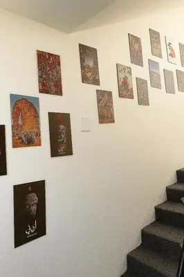 a wall with pictures and photographs on it at Beit Ahlam Quiet Duplex Villa with Terrace and Scenic View near Umm Qais Ruins in Um Qeis