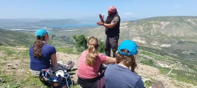 a group of people sitting on top of a mountain at Beit Philodemus 2 in Um Qeis