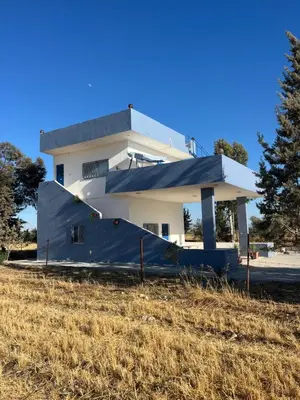 a house with a blue tarp in front of it at Beit Philodemus 2 in Um Qeis