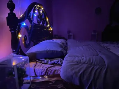 a purple room with a bed with a helmet on it at Luxury couple room in irbid in Irbid
