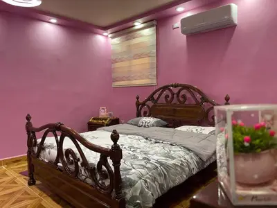 a bedroom with a bed in a pink wall at Luxury couple room in irbid in Irbid