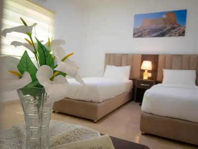 a vase of flowers on a table in a hotel room at Petra Jewel Hotel in Wadi Musa