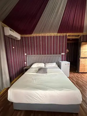 a bedroom with a large bed in a tent at Kinda Rum Luxury Camp in Wadi Rum