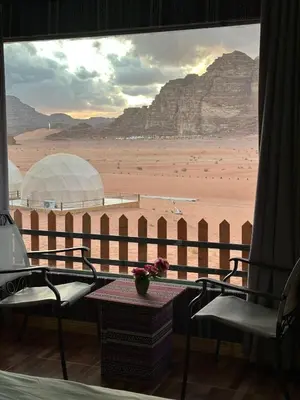 a room with a view of a desert from a window at Kinda Rum Luxury Camp in Wadi Rum