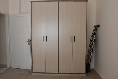 a large wooden cabinet in a room at Furnished Apartment شقة مفروشة in Irbid