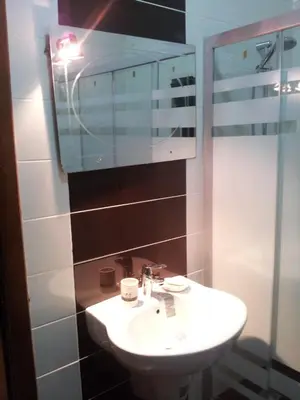 a bathroom with a sink and a mirror at Family apartment in Abdoun Al Janobi in Amman