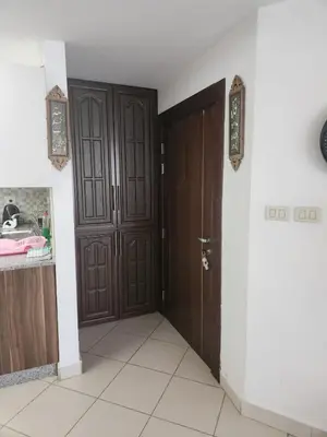 a hallway with two brown doors in a room at 4th circle embassy district 2 bedrooms الدوار الرابع حي السفارات in Amman