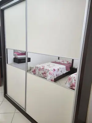 a mirror in a room with two beds at 4th circle embassy district 2 bedrooms الدوار الرابع حي السفارات in Amman