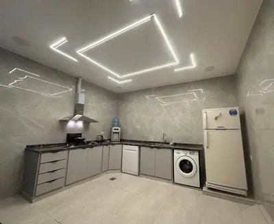 a kitchen with a refrigerator and a washer at Hassan