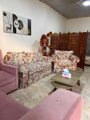 a living room with two couches and a table at دار زمان Zaman Suites Old Town in Al Mafraq