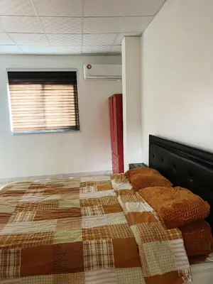 a bedroom with a bed with a quilt on it at دار زمان Zaman Suites Old Town in Al Mafraq