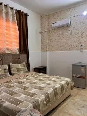 a bedroom with a bed and a air conditioner on the wall at دار زمان Zaman Suites Old Town in Al Mafraq