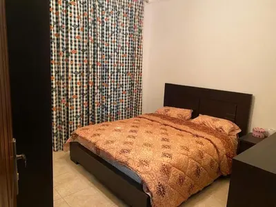 a bedroom with a bed and a large curtain at Bourbaki house