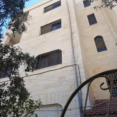 a tall brick building with windows on the side of it at Bourbaki house