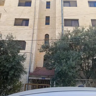 a large brick building with a window in front of it at Bourbaki house