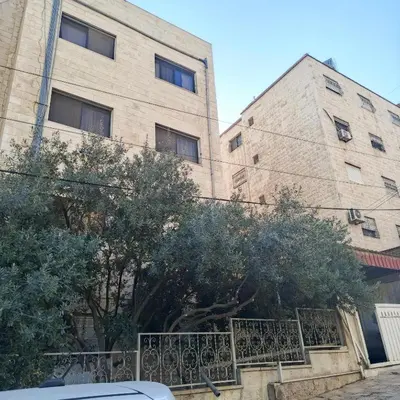 a large building with trees in front of it at Bourbaki house