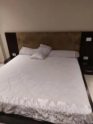 a large white bed with two pillows on it at Full sky apartment in Irbid