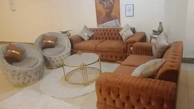 a living room with couches and chairs and a table at Full sky apartment in Irbid