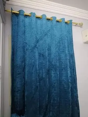 a blue shower curtain hanging on a rod at Full sky apartment in Irbid